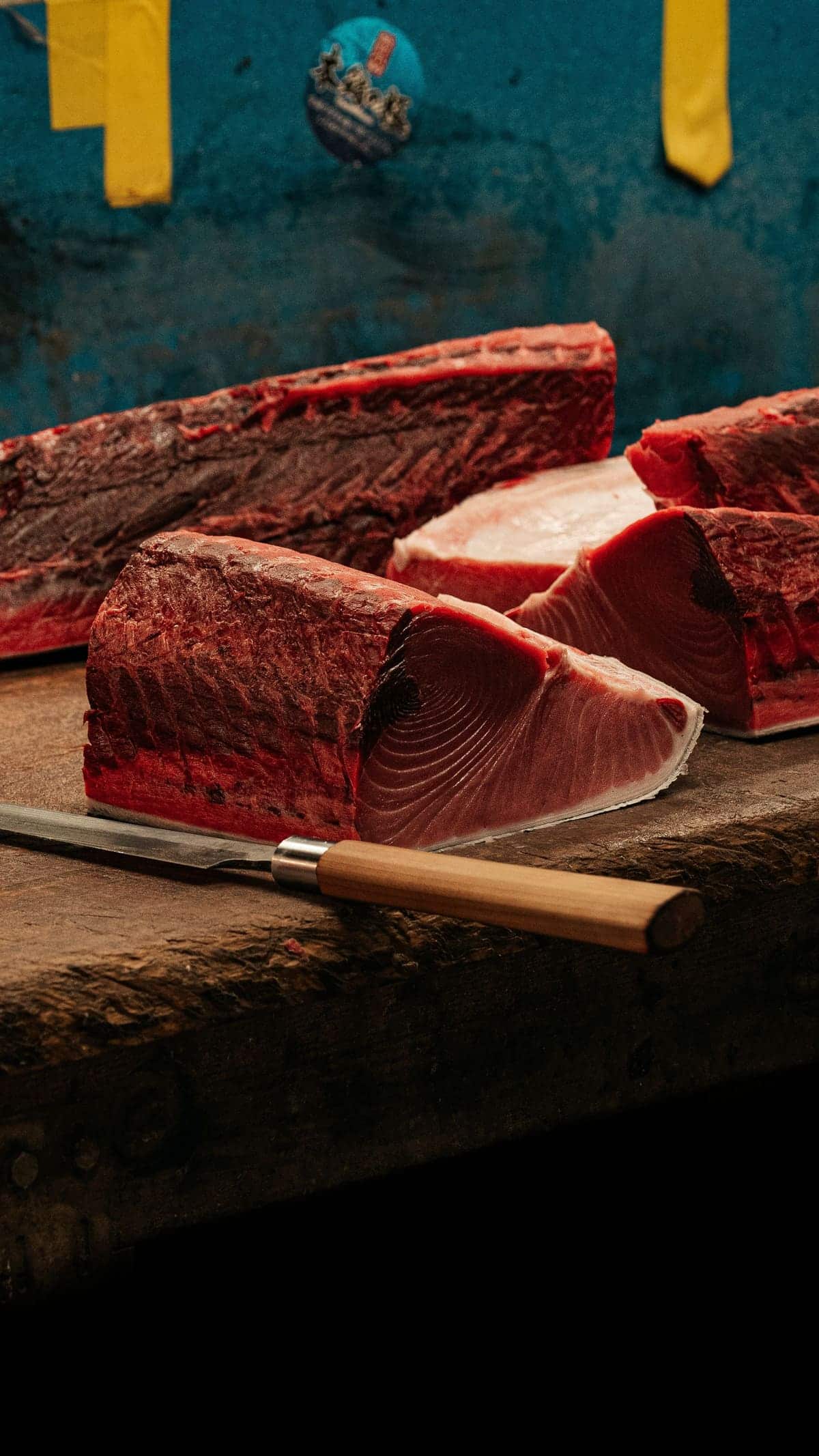 Blocks of raw tuna on a wooden board, a fish safe to eat when the species ID is confident